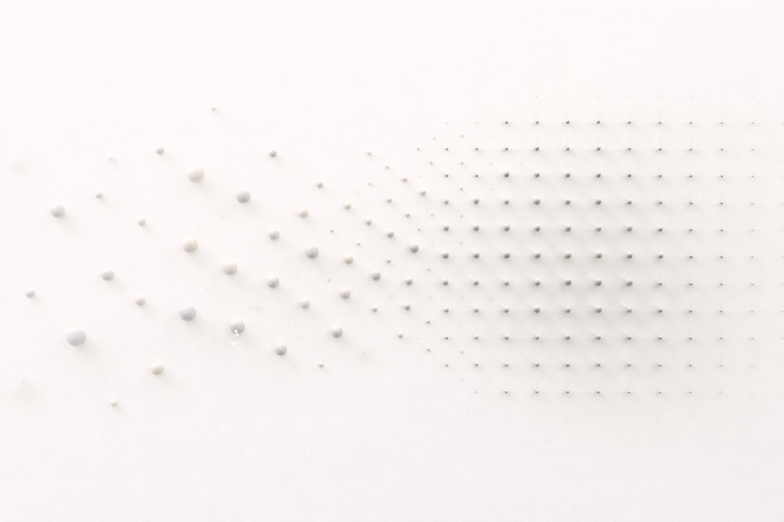 Minimalist abstract illustration showing particles transitioning from a scattered, disordered arrangement into a structured, repeating grid pattern, representing the shift from instability to stable order.
